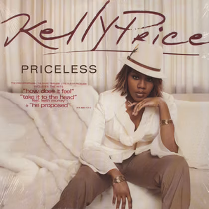 Singer Kelly Price posing in a white hat and blazer on the Priceless album cover